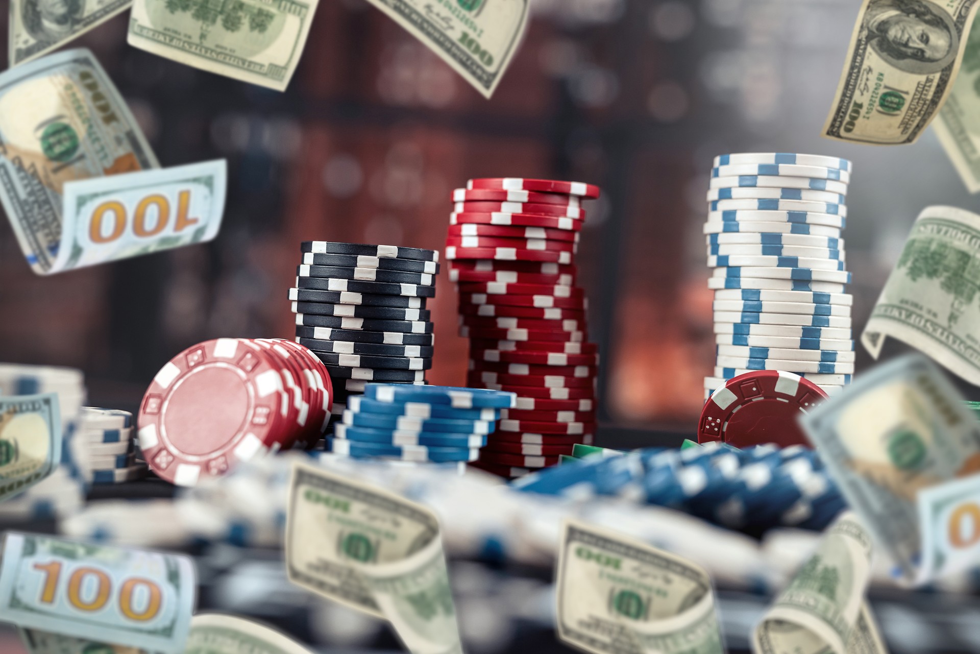 poker chips stack on table at casino, rain money fly dollar as big chance to win